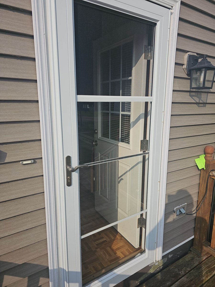 Double entry front door with storm door installed on Connecticut home