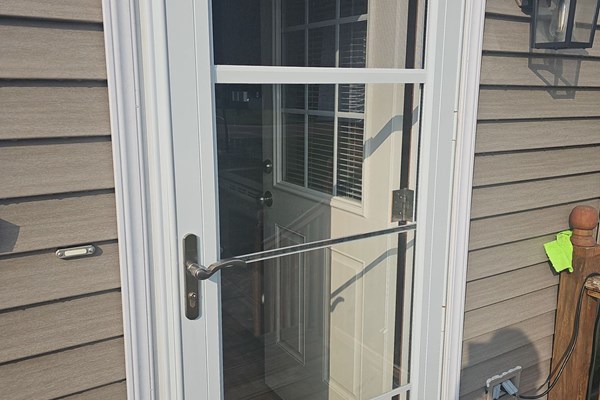 Double entry front door with storm door installed on Connecticut home