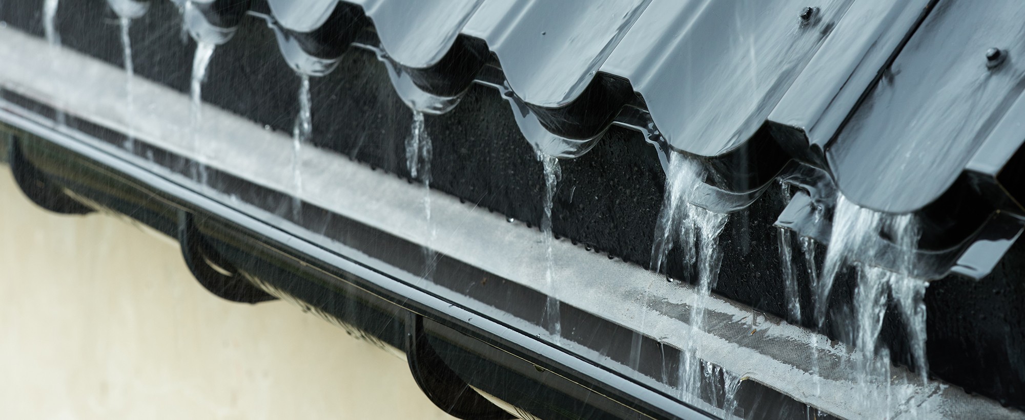 Gusseted metal roof and half round gutter system on Connecticut home
