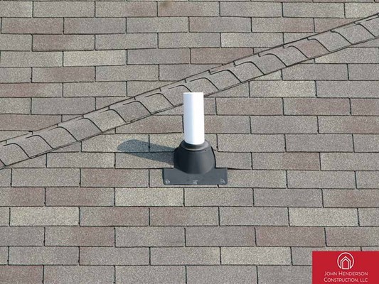 Asphalt shingles with roof boot on residential home roof